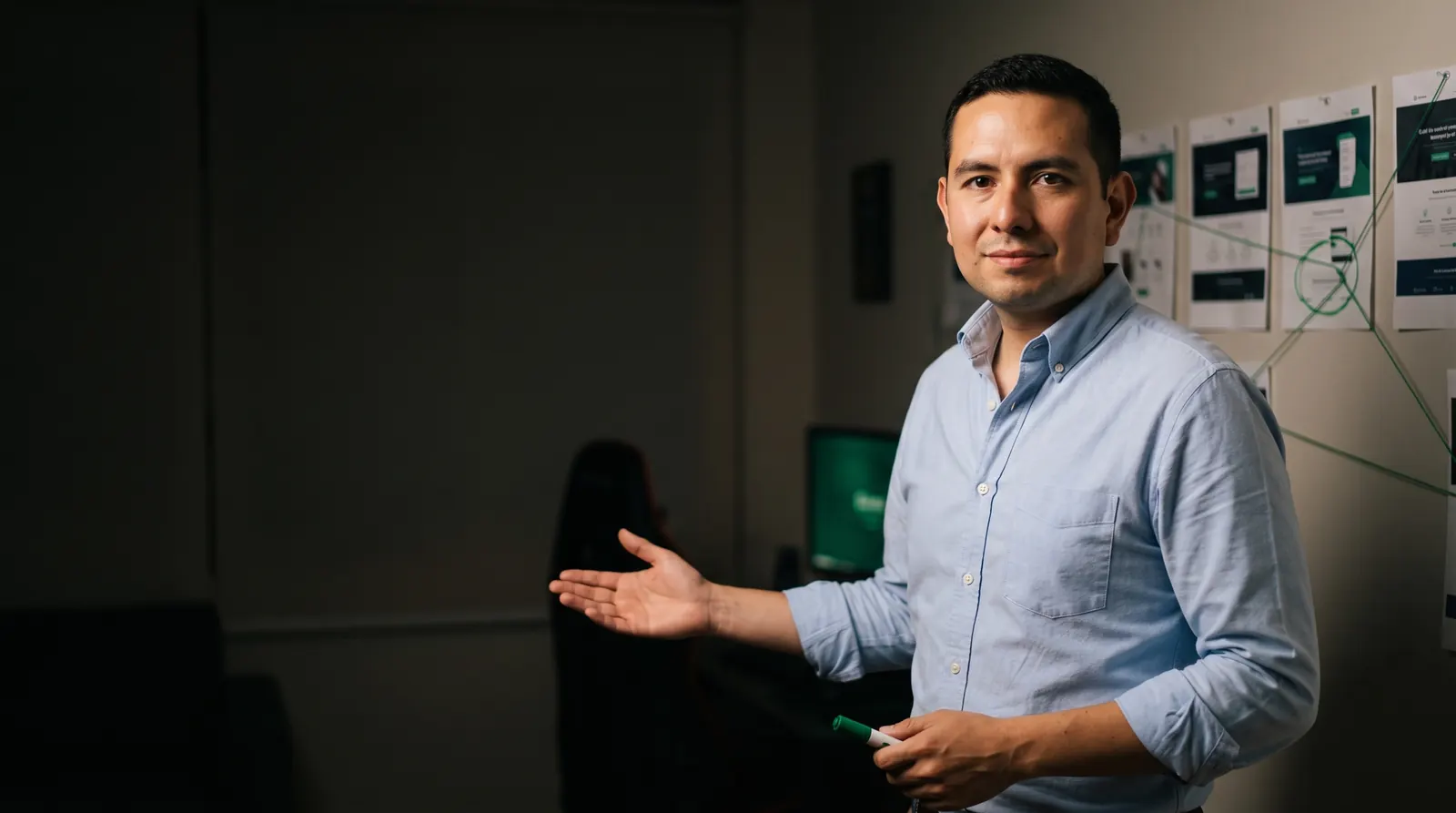Martin Meneses in a light blue shirt, gesturing toward the text, in front of a wall of sales pages connected by green thread